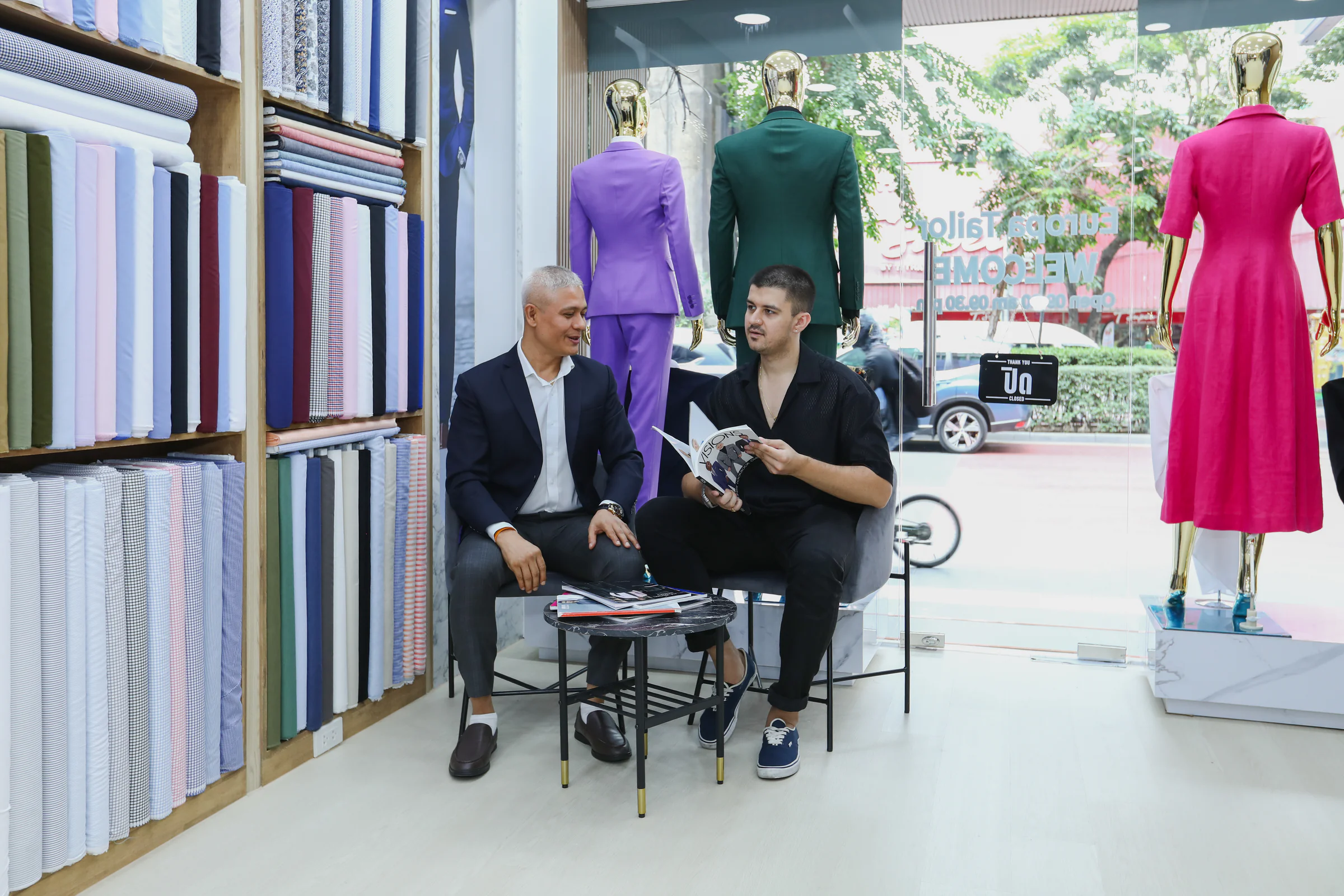 Jack and a client discussing garment ideas together in the Thonglor showroom